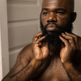 man rubbing zenore beard oil into beard