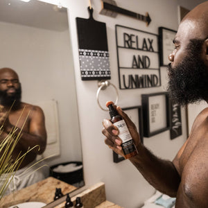man spraying zenore beard conditioner into beard
