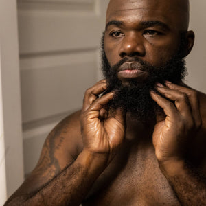man rubbing zenore beard oil into beard