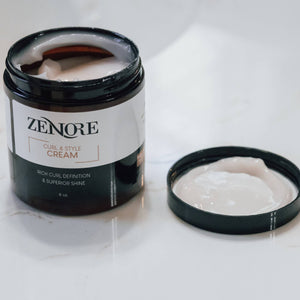 open zenore curl & style cream container sitting on marble counter