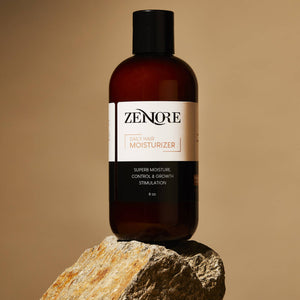 zenore daily hair moisturizer sitting on a rock